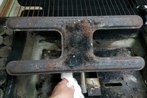 This burner needs to been cleaning. Use a wire brush to lightly to remove the rust build-up.